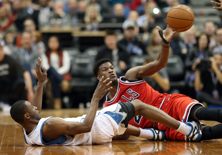 Minnesota Timberwolves' Andrew Wiggins, gets off a pass past Chicago Bulls' Jimmy Butler as the two hit the floor in in Minneapolis in November. The teams will play in Winnipeg in October.