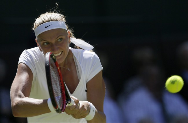 Petra Kvitova of the Czech Republic returns a ball to Kiki Bertens of the Netherlands during their singles first round match at the All England Lawn Tennis Championships in Wimbledon, London, Tuesday June 30, 2015. (AP Photo/Tim Ireland).