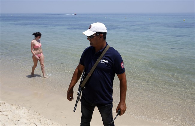 A Tunisian police officer guards the beach area in front of the attacked Imperial Marhaba Hotel in Sousse, Tunisia, Sunday, June 28, 2015. 