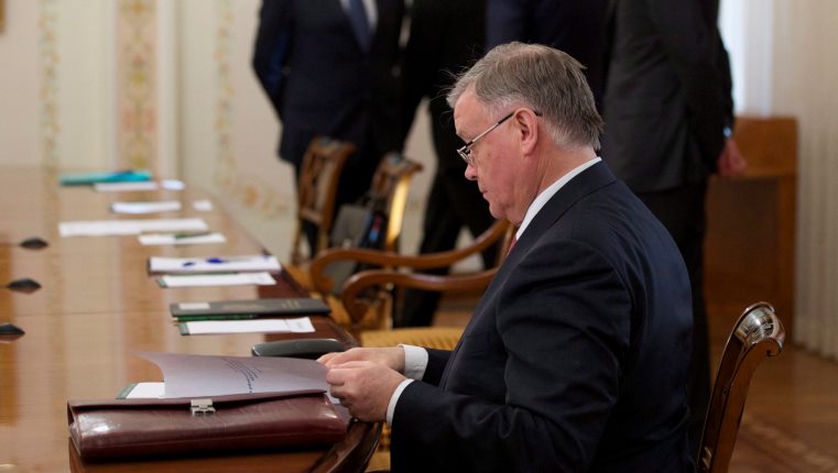 Russian Railways Chief Vladimir Yakunin, foreground, reads documents while waiting for Russian President Vladimir Putin, prior to his meeting with the CEO of Siemens AG , Joe Kaeser, in the Novo-Ogaryovo residence outside Moscow, Russia, Wednesday, March 26, 2014. 