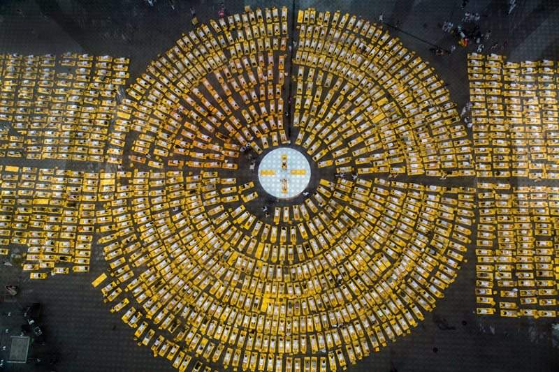 Hundreds of people attend ayoga session under the Eiffel Tower in Paris on June 21, 2015. The event was organized by sportswear brand Lolë and marked the first international Yoga Day.