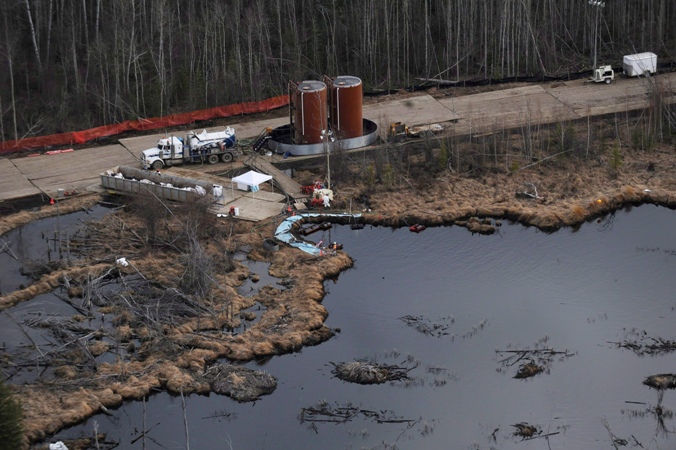 Crews cleanup a pipeline break northeast of Peace River, Alta. on May 4, 2011.