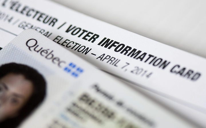 A Quebec driver's license and voter information card are shown in Montreal, March 27, 2014.