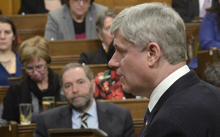 Prime Minister Harper speaks in the House of Commons on Tuesday, March 24, 2015. Opposition Leader Tom Mulcair listens in background.