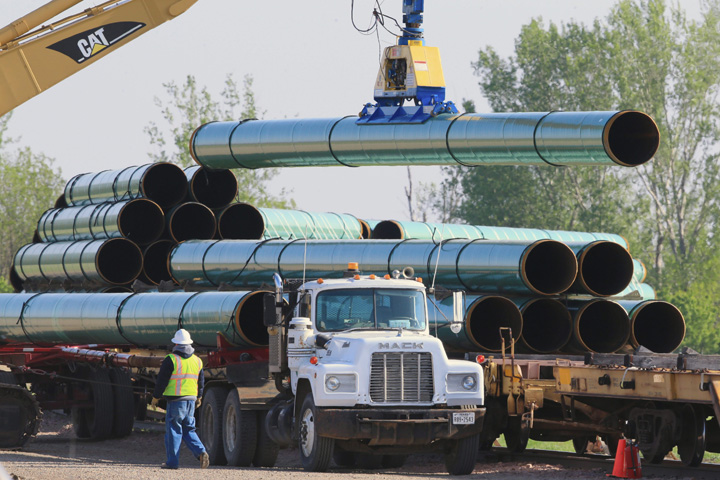Pipes for the proposed Dakota Access oil pipeline, that would stretch from the Bakken oil fields in North Dakota to Patoka, Ill., are unloaded from rail cars Saturday, May 9, 2015, at a staging area in Worthing, S.D. 