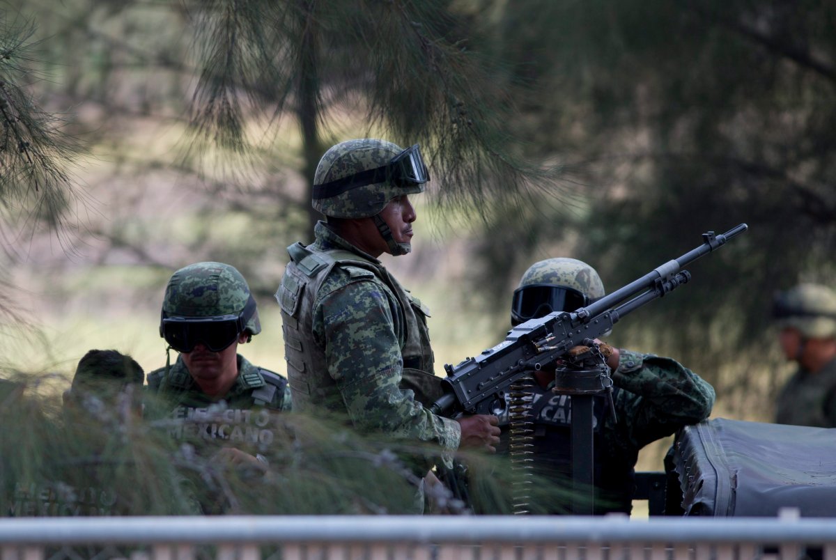 Mexican Army soldiers stand guard near Ecuanduero, in western Mexico, Friday, May 22, 2015.