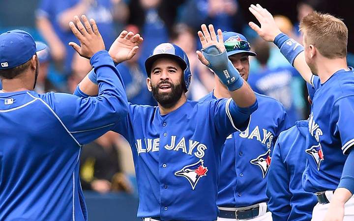 Toronto Blue Jays' Jose Bautista celebrates with teammates after scoring on a two-run walk-off single in the ninth inning of MLB action against the Houston Astros on Sunday, June 7, 2015.