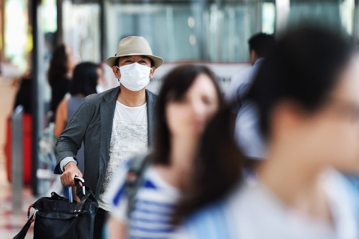 A traveller is seen wearing facial masks while arriving at Suvarnabhumi Airport in Bangkok, Thailand, June 20, 2015. 