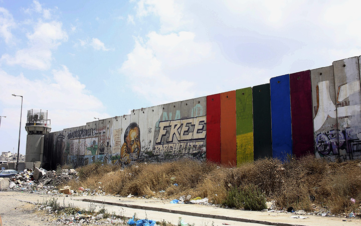 This Monday, June 29, 2015 photo provided by Palestinian artist Khaled Jarrar shows his painting of a rainbow flag on six slabs of the West Bank separation barrier in the West Bank city of Ramallah. 