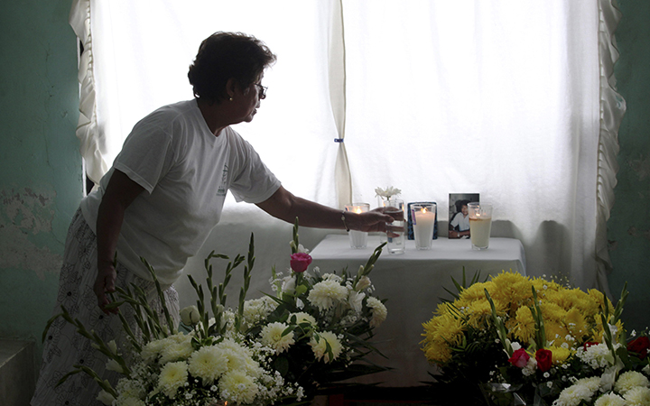A woman arranges an altar at the home of journalist Juan Mendoza Delgado as relatives wait for the arrival of the coffin containing his remains in the town of Medellin, state of Veracruz, Mexico. According to police authorities, Delgado was killed in a hit and run but his family and human rights groups are demanding a full investigation.