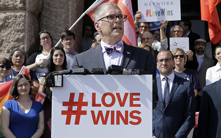 Jim Obergefell, the named plaintiff in the Obergefell v. Hodges Supreme Court case that legalized same sex marriage nationwide, is backed by supporters of the courts ruling on same-sex marriage on the step of the Texas Capitol during a rally in Austin, Texas on June 29, 2015. 