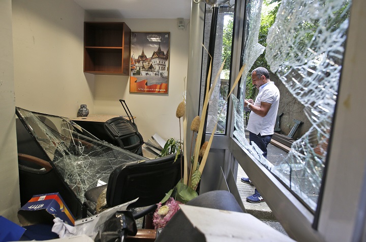 A worker inspects damage at the Thai consulate in Istanbul, Thursday, July 9, 2015. A group of protesters stormed the consulate overnight, smashing windows and breaking in to the offices, where they destroyed pictures and furniture and hurled files out into the yard, to denounce Thailands decision to deport ethnic Uighur migrants back to China. Turkey has cultural ties to the minority Muslim Uighurs and pro-Uighur groups fear Uighurs face persecution by the Chinese government. (AP Photo/Emrah Gurel).