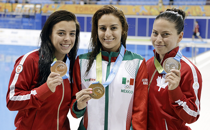 Paola Espinosa, center, of Mexico, holds her gold medal as Roseline Filion, left, of Canada, holds her silver medal and Meaghan Benfeito, right, of Canada, holds her bronze medal after the finals of the women's 10-meter platform diving event at the Pan Am Games Saturday, July 11, 2015, in Toronto.