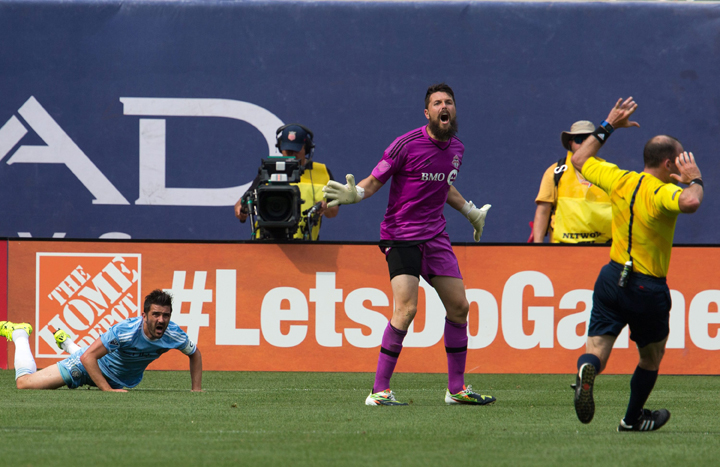 Toronto FC goalkeeper Chris Konopka, center, reacts as a penalty kick his awarded to New York City FC forward David Villa, left, during the second half of the match between New York City FC and Toronto FC, Sunday, July 12, 2015, at Yankee Stadium in New York.