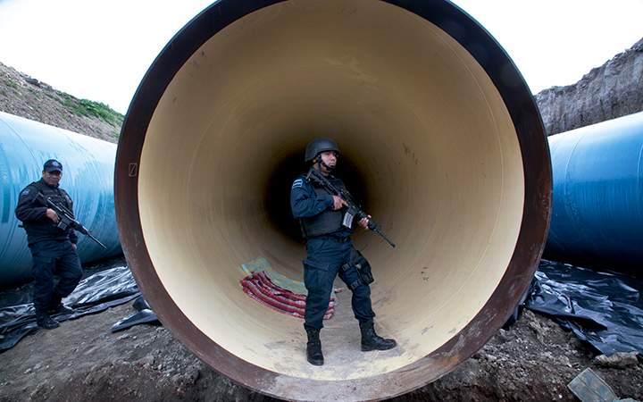 Mexican Federal Police guard a drainage pipe outside of the Altiplano maximum security prison in Almoloya, west of Mexico City. Mexico's most powerful drug lord, Joaquin "El Chapo" Guzman, escaped from a maximum security prison through a tunnel that opened into the shower area of his cell.