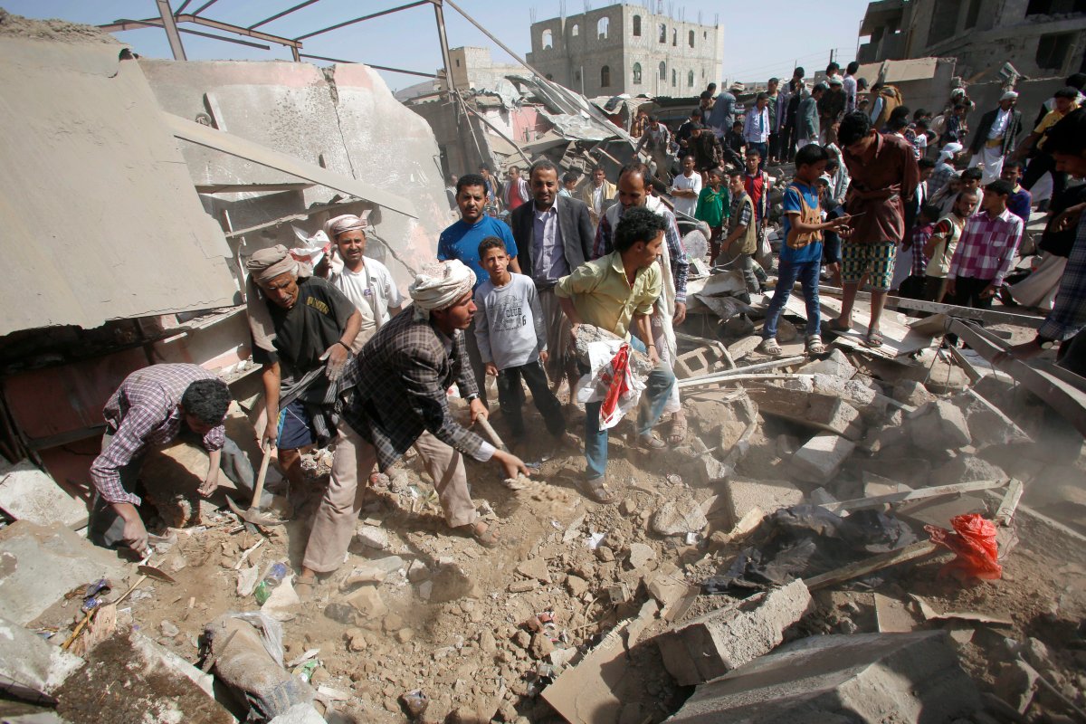 People search for survivors under the rubble of shops destroyed by a Saudi-led airstrike at a market in Sanaa, Yemen, Monday, July 20, 2015. 