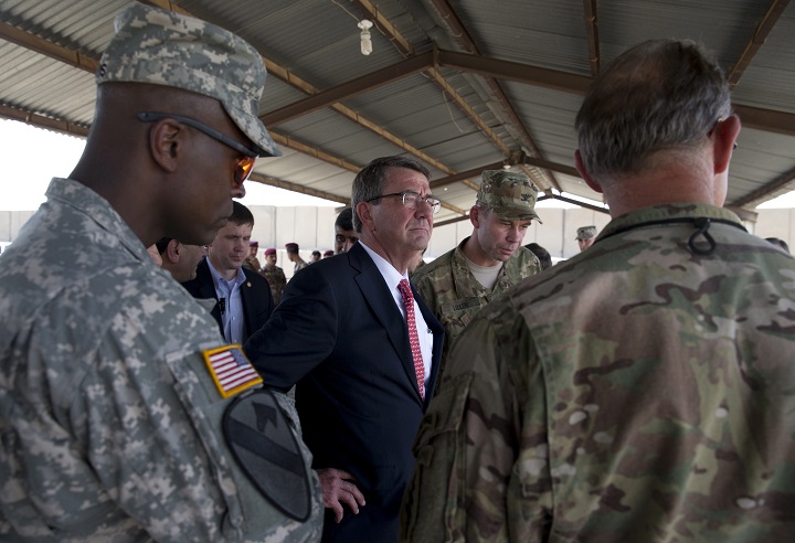 U.S. Defense Secretary Ash Carter, center, stands with Col. Otto Liller, commander, 1st Special Forces Group (Airborne), second from right, as he observes Iraqi Counter Terrorism Service forces participate in a training exercise at the Iraqi Counter Terrorism Service Academy on the Baghdad Airport Complex in Baghdad, Iraq, Thursday, July 23, 2015. Carter is on a weeklong tour of the Middle East focused on reassuring allies about Iran and assessing progress in the coalition campaign against the Islamic State in Syria and Iraq. (AP Photo/Carolyn Kaster, Pool).