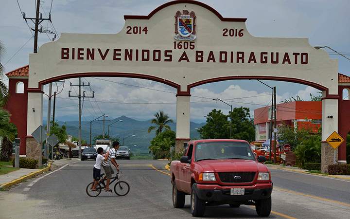 A car drives past the entrance to the town of Badiraguato, Mexico, the hometown of drug lord Joaquin “El Chapo” Guzman.