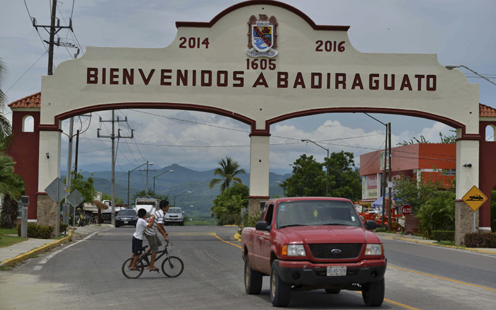 A car drives past the entrance to the town of Badiraguato, Mexico, the hometown of drug lord Joaquin “El Chapo” Guzman.
