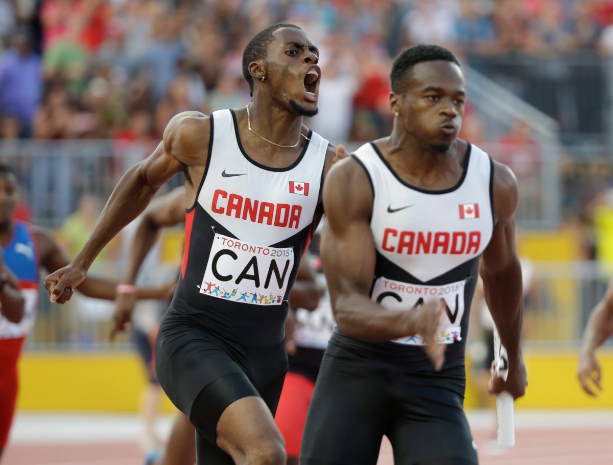 Canada's Brendon Rodney, left, screams after handing off the baton to Aaron Brown in the finals of the men's 4x100 meter relay at the Pan Am Games in Toronto, Saturday, July 25, 2015.