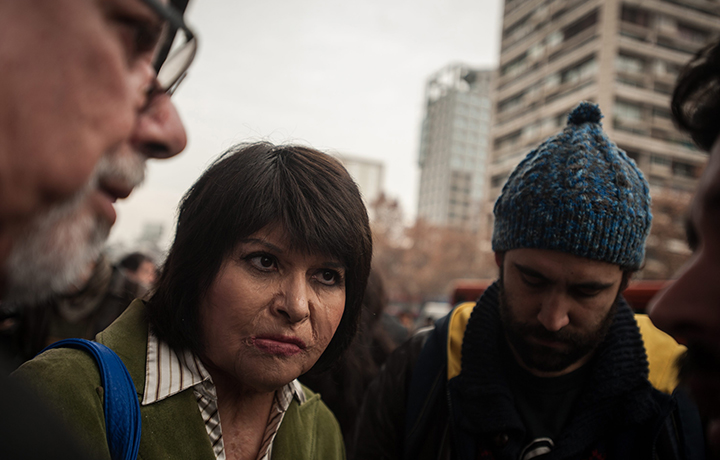 Chilean Carmen Gloria Quintana, who along with then 19-year-old Rodrigo Rojas was allegedly doused with gasoline and set aflame by a military patrol in 1986 and then left for dead takes part to a demonstration to demand justice for his murder, in Santiago, on July 28, 2015.