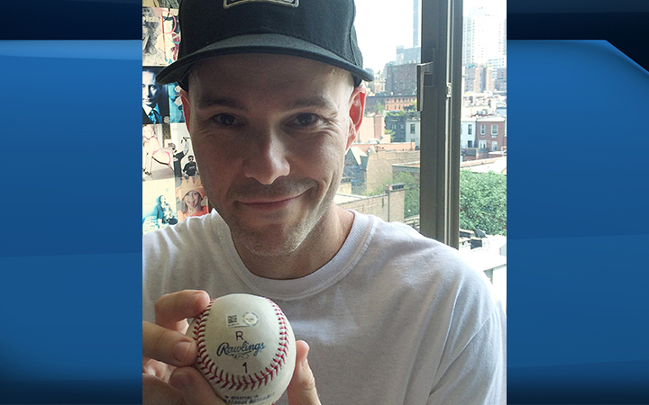 Zack Hample poses with the baseball he caught on June 19th, after it was hit by New York Yankees' Alex Rodriguez for a home run and his 3000th hit, at his home in New York, Friday, July 3, 2015.