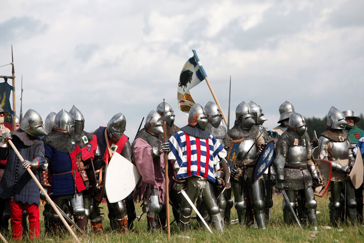 People wear armor as they attend a reenactment of the Battle of Agincourt, in Agincourt, northern France, Saturday, July 25, 2015.