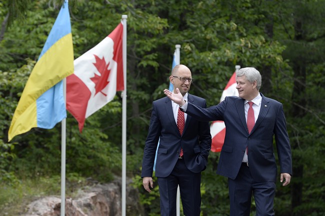 Canadian Prime Minister Stephen Harper meets with Ukrainian Prime Minister Arseniy Yatsenyuk at Willson house in Chelsea, Que., Tuesday, July 14.