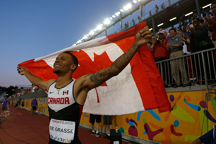 Canada's Andre De Grasse celebrates after winning the final of the men’s 100m race at the Pan Am Games in Toronto, Wednesday, July 22, 2015. 