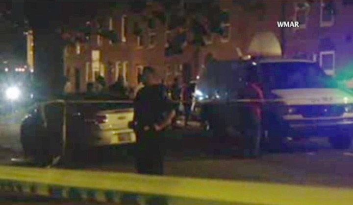 In this image taken from video, police investigate the scene of a shooting, Tuesday, July 7, 2015, in Baltimore. 