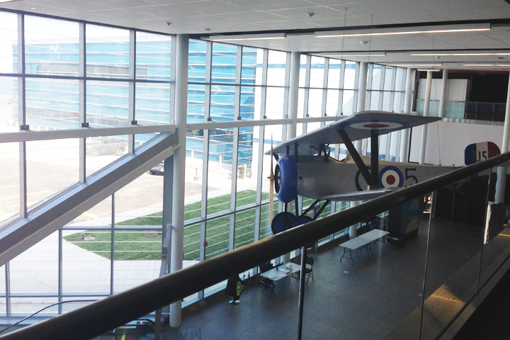 A replica of Billy Bishop's Nieuport 17 is suspended over the escalators bringing passengers from the tunnel to the terminal.
