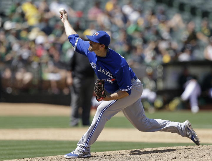 Toronto Blue Jays pitcher Bo Schultz works against the Oakland Athletics in the ninth inning of a baseball game Thursday, July 23, 2015, in Oakland, Calif. 