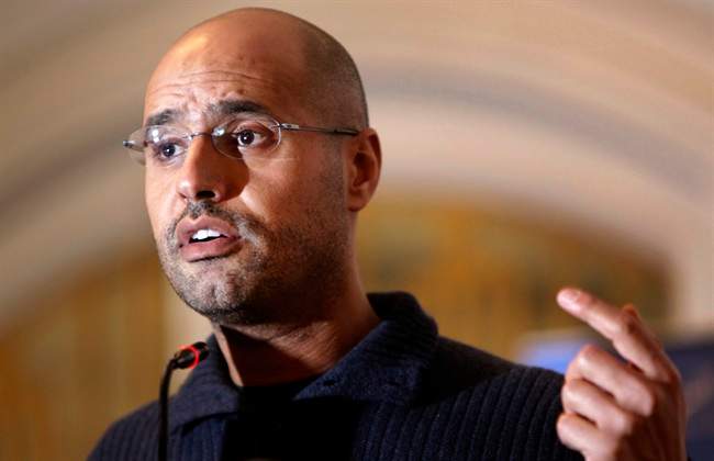 FILE - In this Feb. 25, 2011, file photo, Seif al-Islam Gadhafi, son of Libyan leader Moammar Gadhafi, speaks to the media at a press conference in a hotel in Tripoli, Libya. A Libyan court sentenced Seif al-Islam, to death over killings in 2011 uprising on Tuesday, July 28, 2015. (AP Photo/Ben Curtis, File).