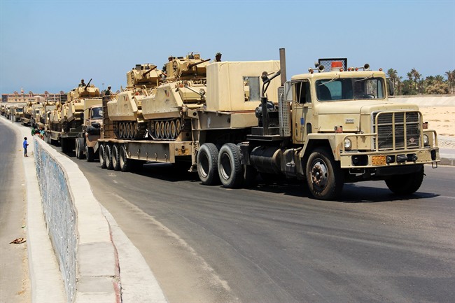 In this Thursday, Aug. 9, 2012 file photo, army trucks carry Egyptian tanks in a military convoy in El Arish, Egypt's northern Sinai Peninsula.