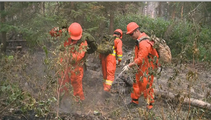 Canadian Forces members trade camouflage gear for jumpsuits as the join the fight to battle wildfires in Saskatchewan.