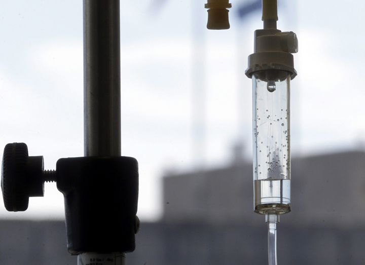In this Sept. 5, 2013 file photo, an infusion drug to treat cancer is administered to a patient via intravenous drip at a cancer center hospital in Durham, N.C. 