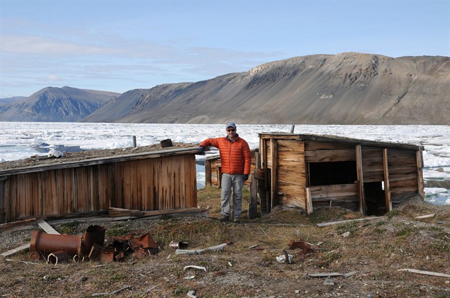 Peter Dawson stands beside huts used by U.S. polar explorer Robert Peary in his quest for the North Pole at Fort Conger on Ellesmere island in a handout photo. A historic fort threatened by melting permafrost in one of the most remote locations on Earth might be preserved thanks to 3D technology. 