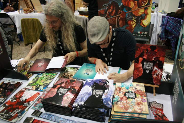 Michel Lacombe and Benoît Godbout sign comics at Montreal Comiccon.