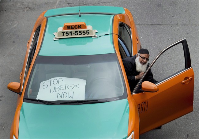 A taxi driver protests Uber in Toronto on June 1, 2015. An Ontario judge has sided with the ride-hailing service Uber in its legal dispute with the City of Toronto.The city sought a permanent injunction on the company's operations, arguing Uber is a taxi company and must abide by the city's regulations. 