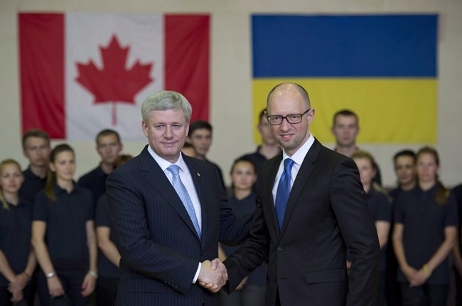 Canadian Prime Minister Stephen Harper shakes hands with Ukraine Prime Minister Arseniy Yatsenyuk during a visit to the Academic Institute of the National Academy of Internal Affairs of Ukraine for Training of Specialists for Public Safety, Psychological Service and National Guard of Ukraine Units in Kyiv, Ukraine on June 6, 2015. Ukraine's prime minister arrives in Ottawa today for what's likely to be the last visit by a foreign government leader ahead of this fall's federal election. The stakes, for Harper, are more than just commercial. THE CANADIAN PRESS/Adrian Wyld.