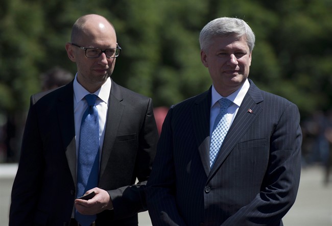 Prime Minister Stephen Harper and Ukraine Prime Minister Arseniy Yatsenyuk are seen in this June 6, 2015 file photo.