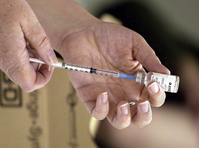 A nurse loads a syringe with vaccine for injection in Victoria, B.C., in this file photo. 