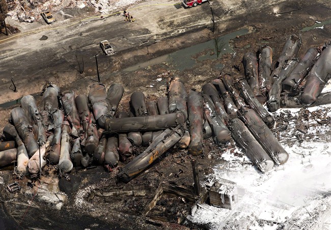 The downtown core lays in ruins as firefighters continue to water the smoldering rubble, Sunday, July 7, 2013 in Lac-Mégantic, Que. after a train derailed igniting tanker cars carrying crude oil. Transport Canada has approved rules intended to reduce the risk of runaway trains in response to recommendations by the Transportation Safety Board following the deadly derailment in Lac-Mégantic, Que.