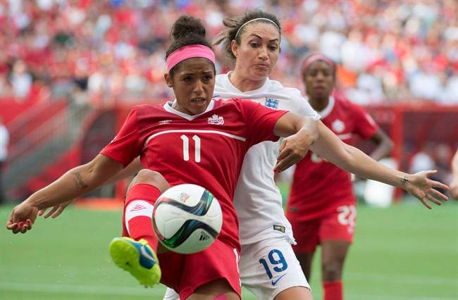 Canada’s Desiree Scott fights for the ball with England\’s Jodie Taylor during second half of FIFA World Cup quarter-final soccer action in Vancouver, B.C. Saturday, June, 27, 2015