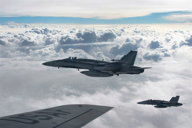Royal Canadian Air Force CF-18 Hornets depart after refueling with a KC-135 Stratotanker assigned to the 340th Expeditionary Air Refueling Squadron, Thursday,  Oct. 30, 2014, over Iraq.