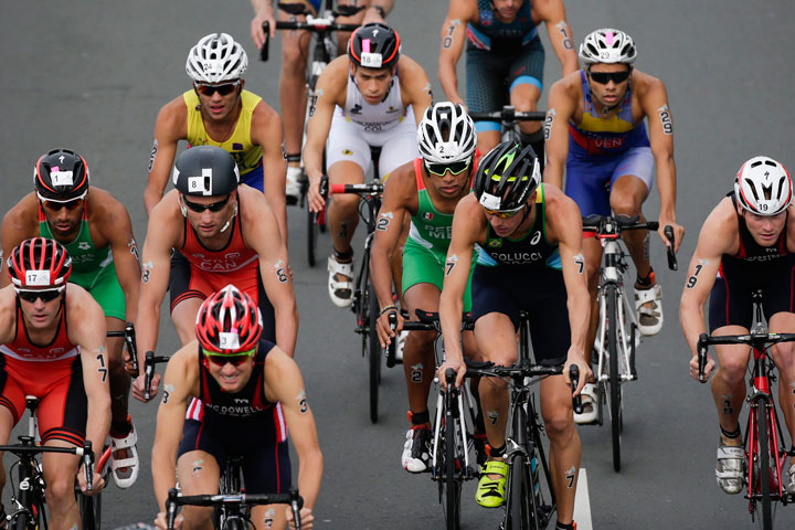 Brazil's Reinaldo Colucci, center, is followed by Mexico's Irving Perez as they ride in the middle of a pack during the Men's Triathlon at the Pan Am Games in Toronto, Ontario, Sunday, July 12, 2015.