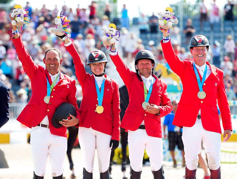 Canadian Equestrian team pictured left to right, Yann Candele, Tiffany Foster, Eric Lamaze and Ian Millar show off their gold medals after winning the team jumping during the Pan American Games in Caledon, Ont., on Thursday, July 23, 2015.