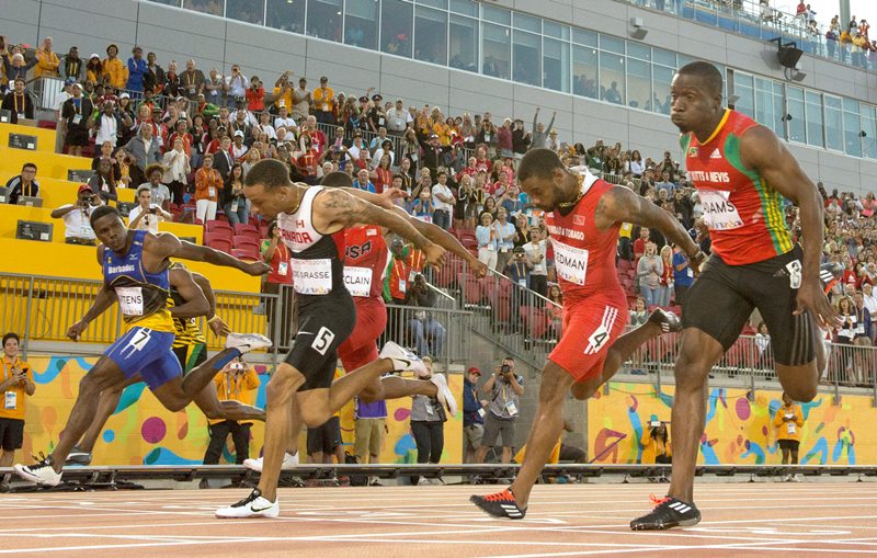 Andre De Grasse, of Canada, (5) wins gold medal in the men's 100m final during the athletics competition at the 2015 Pan Am Games in Toronto on Wednesday, July 22, 2015. 