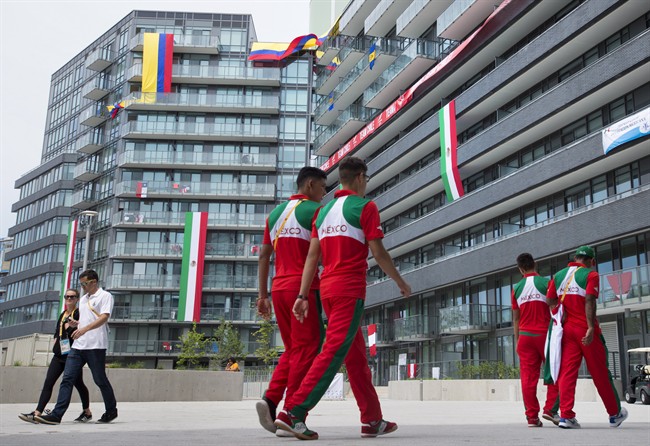 Flags are hung outside windows as athletes make their way through the athletes' village at the 2015 Pan Am Games in Toronto.