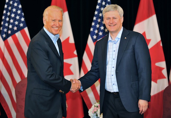 Canadian Prime Minister Stephen Harper, right, and Vice President of the United States Joe Biden participate in a photo opportunity in Vancouver, B.C., on Sunday, July 5, 2015. Vice-President Joe Biden and his wife, Jill, are in Vancouver to cheer on the United States in the Women's World Cup final.